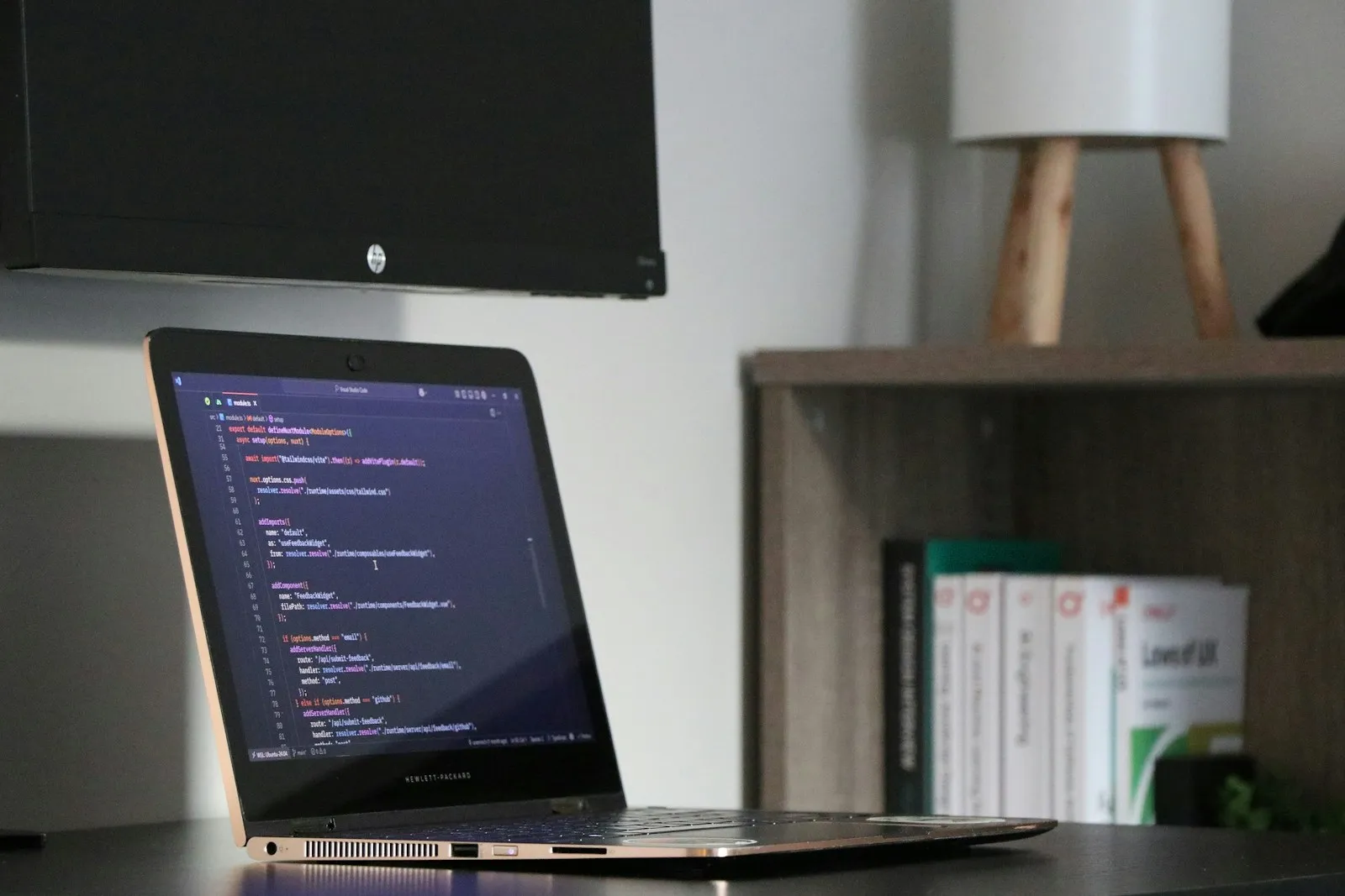 Laptop displaying programming code in a workspace
